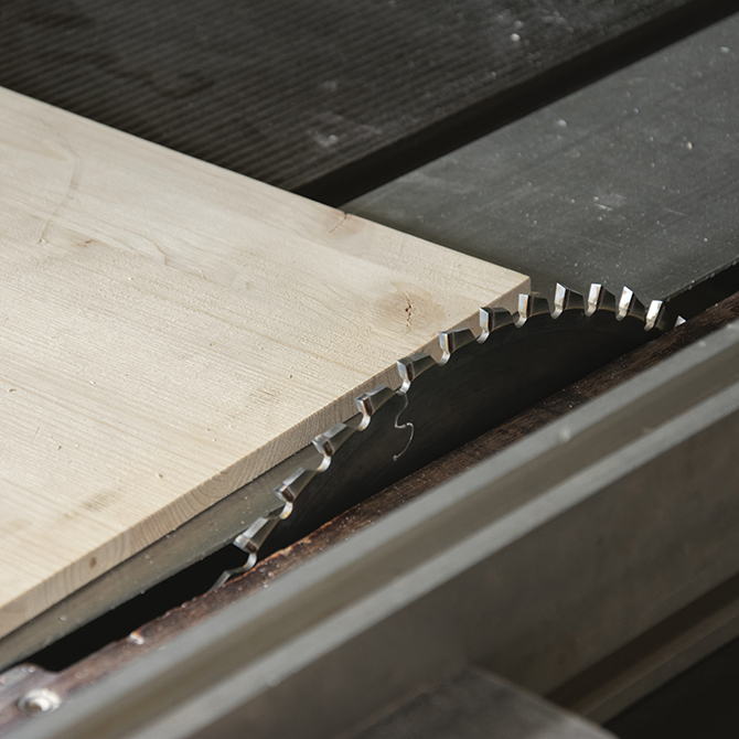 Plywood panel next to table saw blade