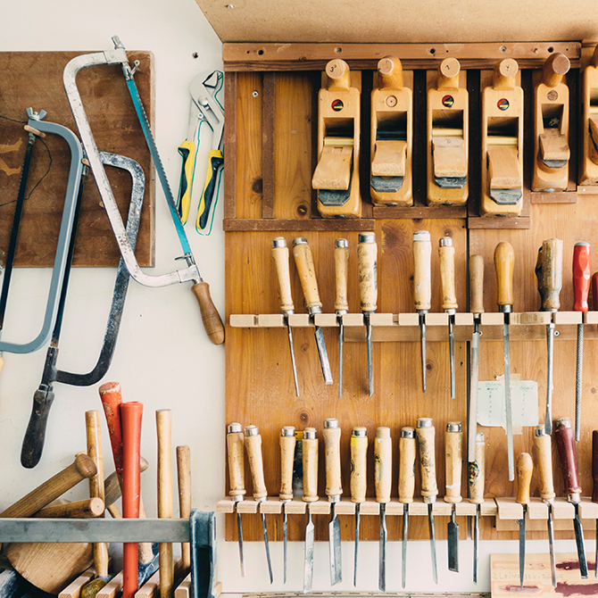 Various woodworking tools hanging on wall organizer
