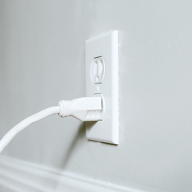 Electrical wall outlet with power cord plugged in